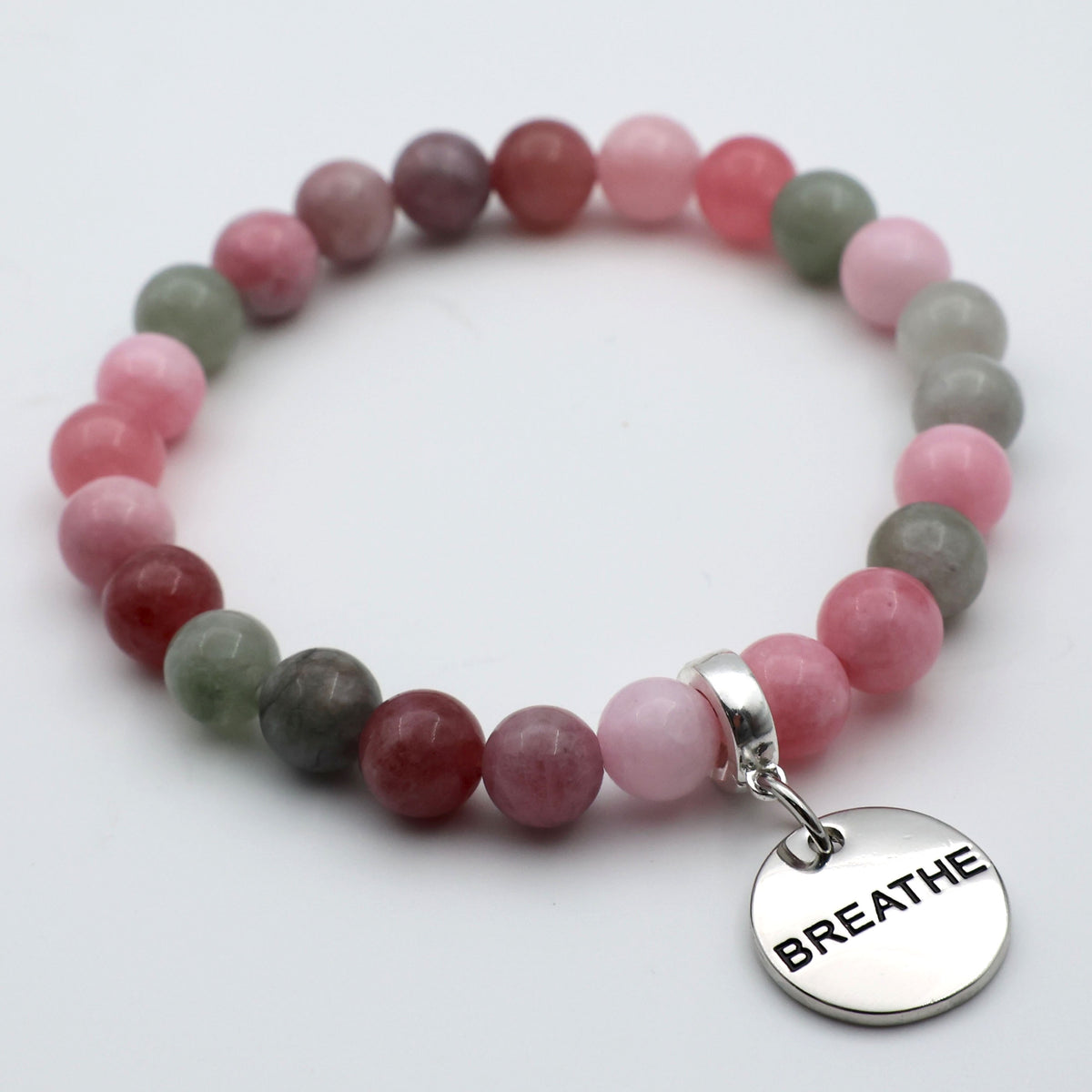 Stones bracelet with 'BREATHE' charm on a white background