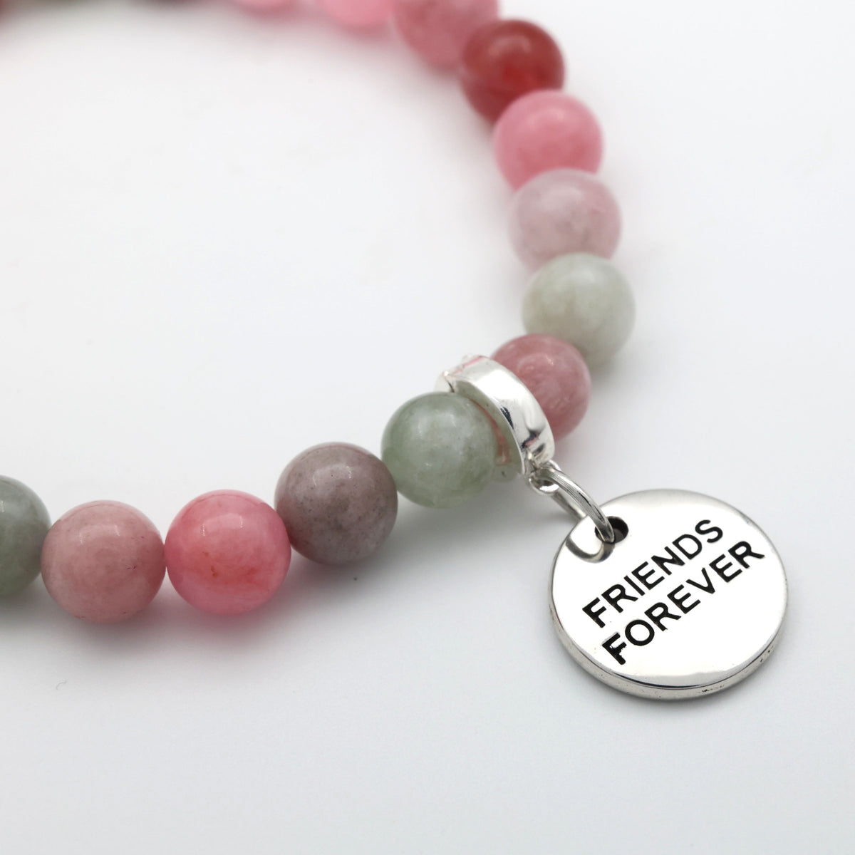 Beaded bracelet with a 'Friends Forever' charm on a white background