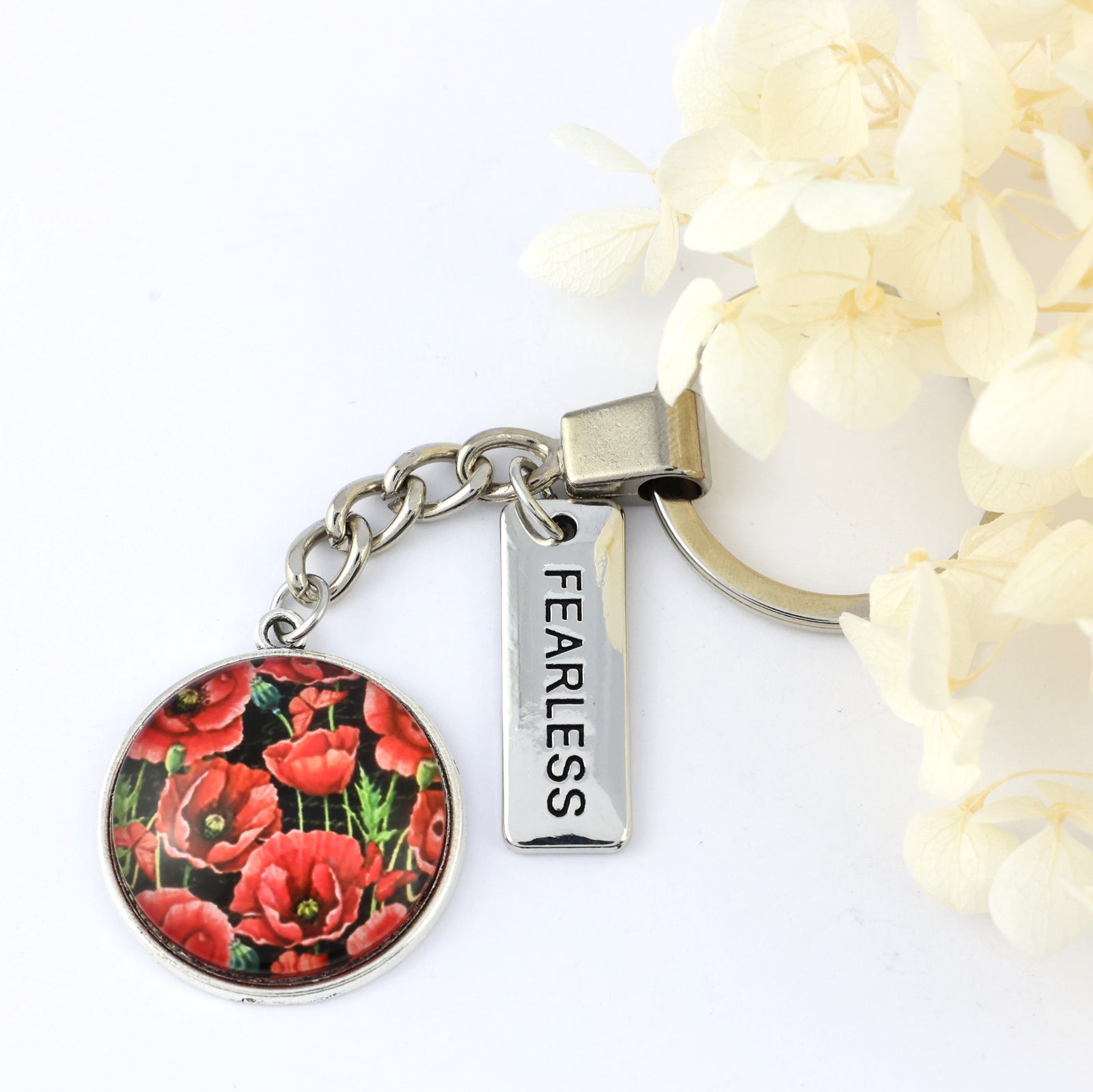 Keychain with floral design and 'FEARLESS' tag on a white background