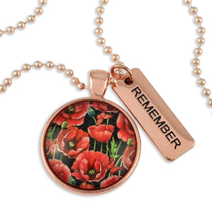 Necklace with floral pendant and 'REMEMBER' tag on a white background