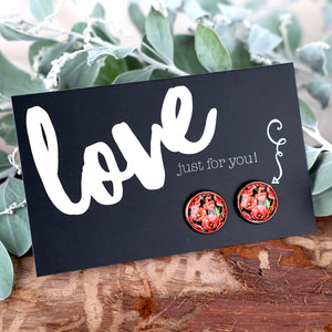 Floral earrings on a 'love just for you!' card with greenery in the background