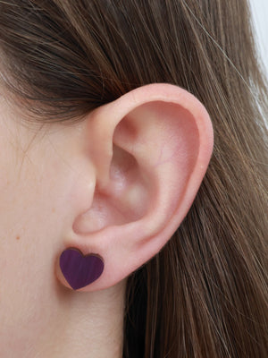 So Loved purple swirl resin acrylic heart stud earrings worn on an ear to show size and fit