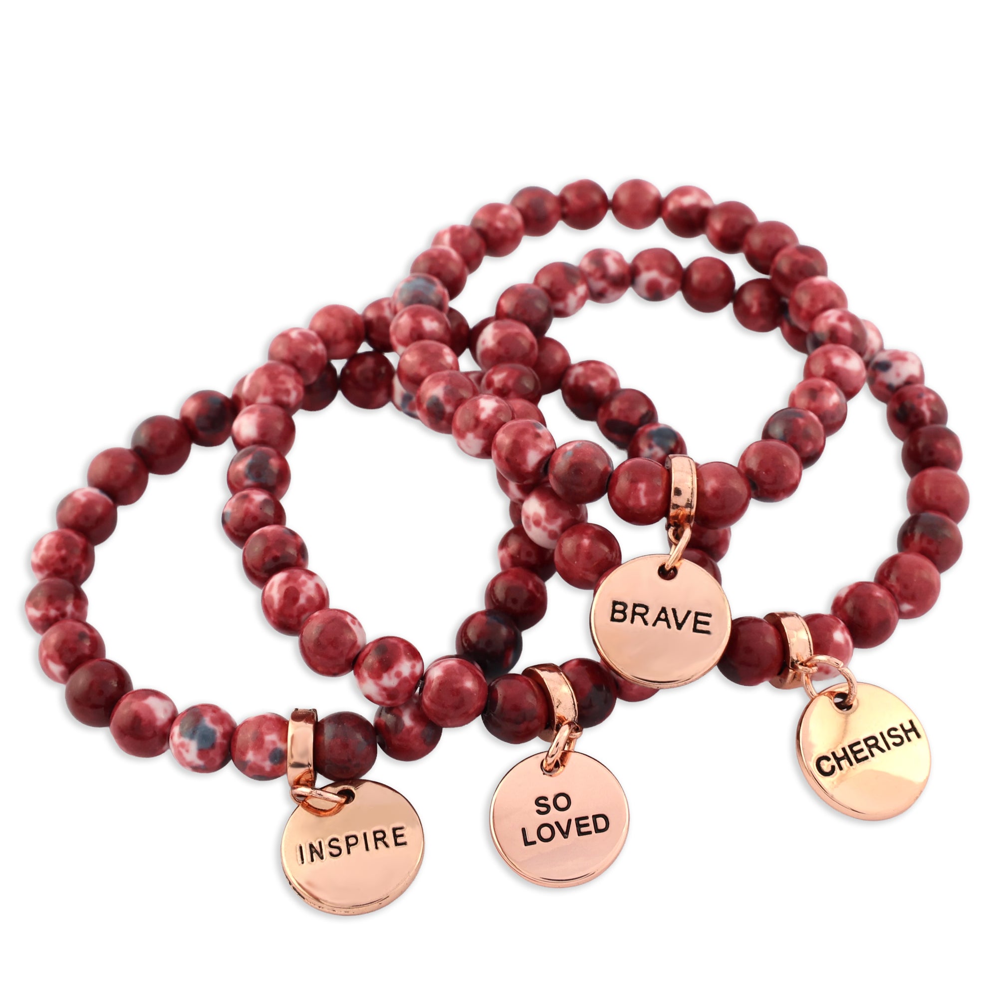 Red beaded bracelets with rose gold charms on a white background