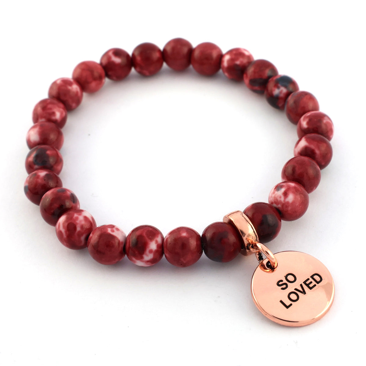 Red beaded bracelet with a rose gold tag reading 'SO LOVED' on a white background
