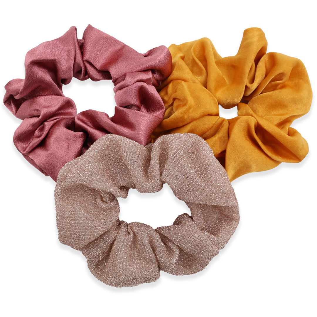 Three colorful scrunchies on a white background