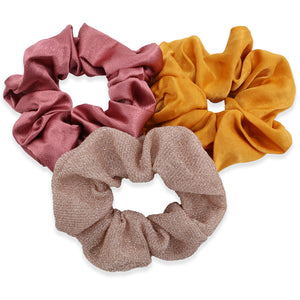Three colorful scrunchies on a white background