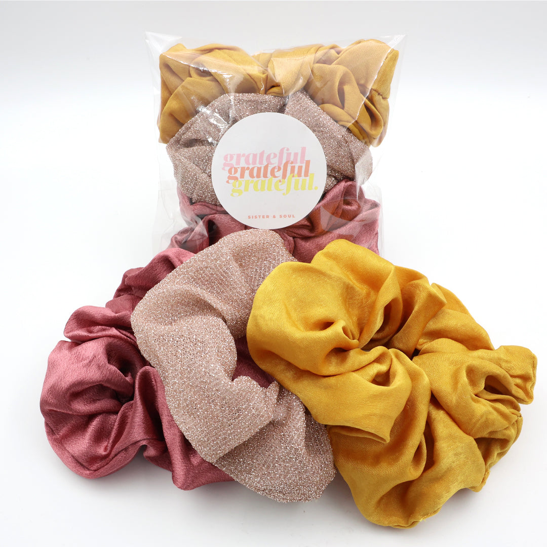Set of colorful scrunchies with a 'grateful' label on a white background