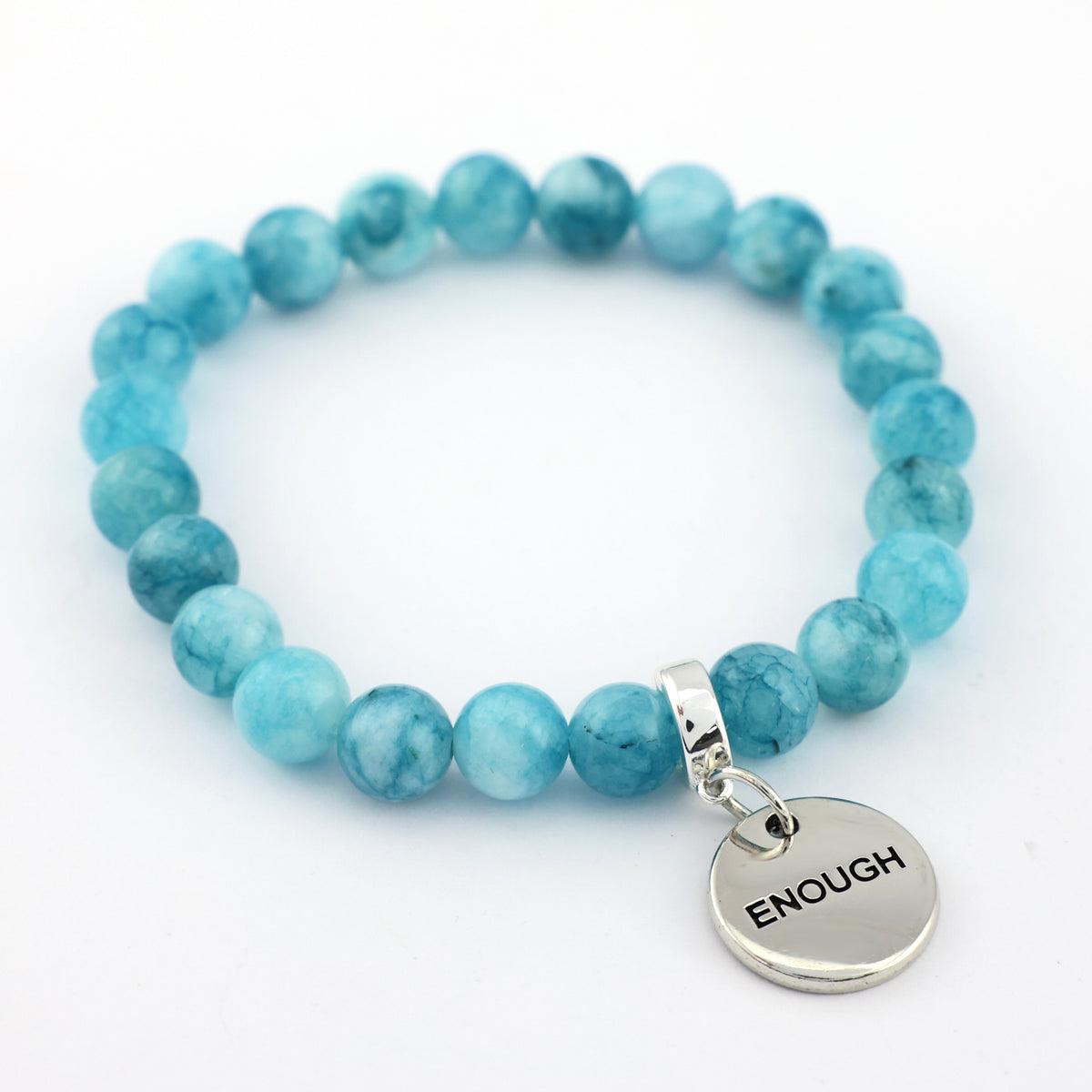 Turquoise beaded bracelet with a silver 'ENOUGH' charm on a white background