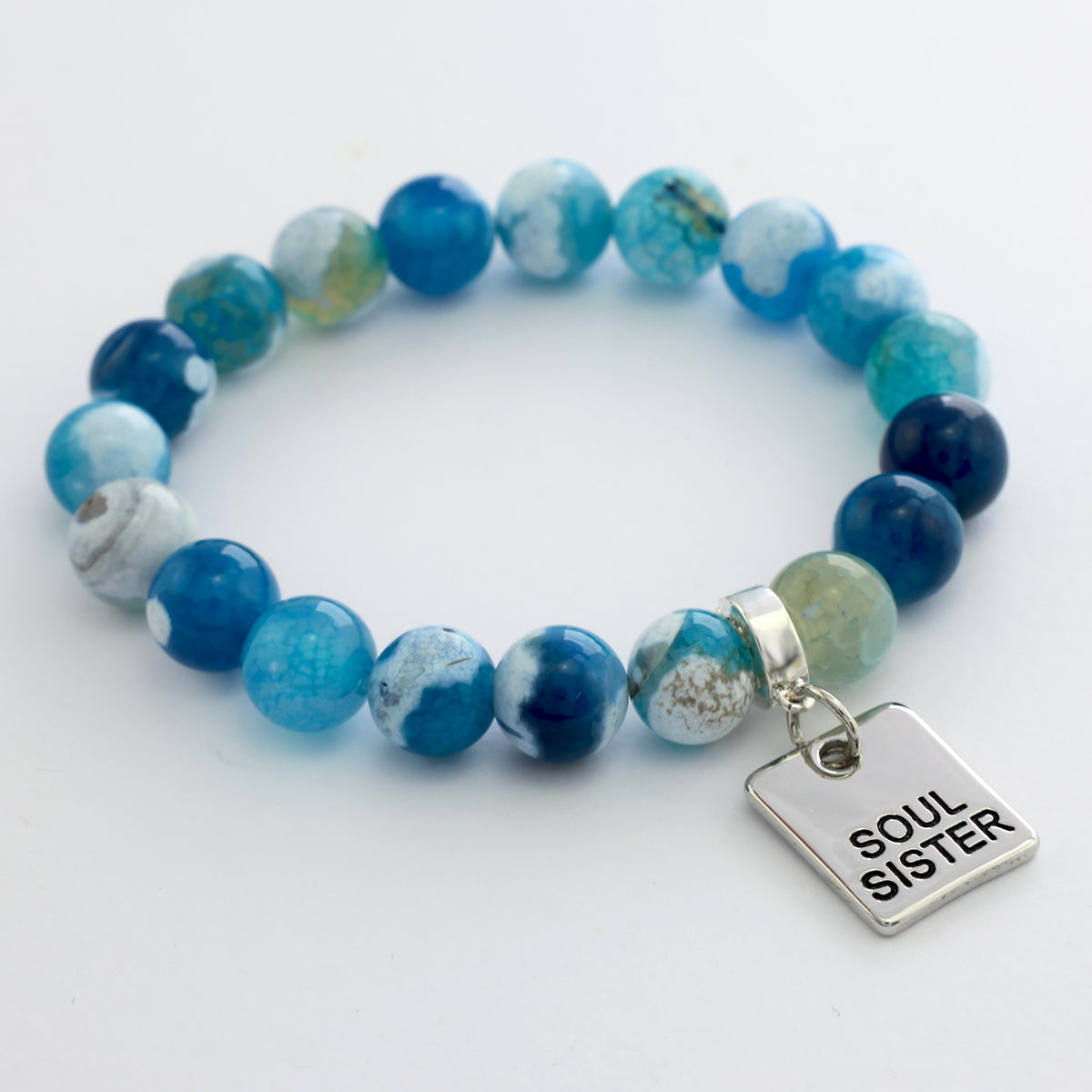 Blue beaded bracelet with 'Soul Sister' charm on a white background