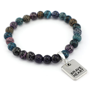 Multicolored beaded bracelet with a 'Brave Heart' charm on a white background