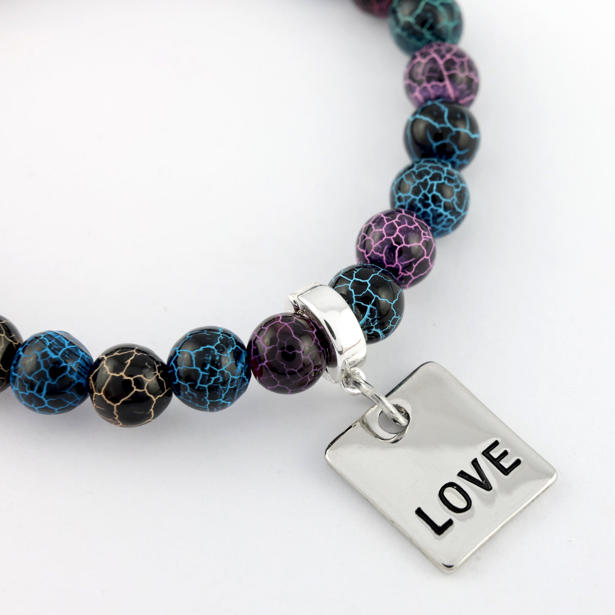 Beaded bracelet with a silver 'LOVE' charm on a white background