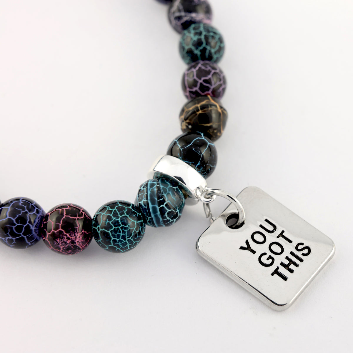 Bracelet with marbled beads and 'YOU GOT THIS' charm on a white background