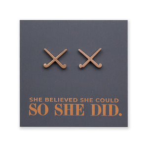 Rose Gold stainless steel hockey shaped earrings on a card with 'She believed she could so she did' text