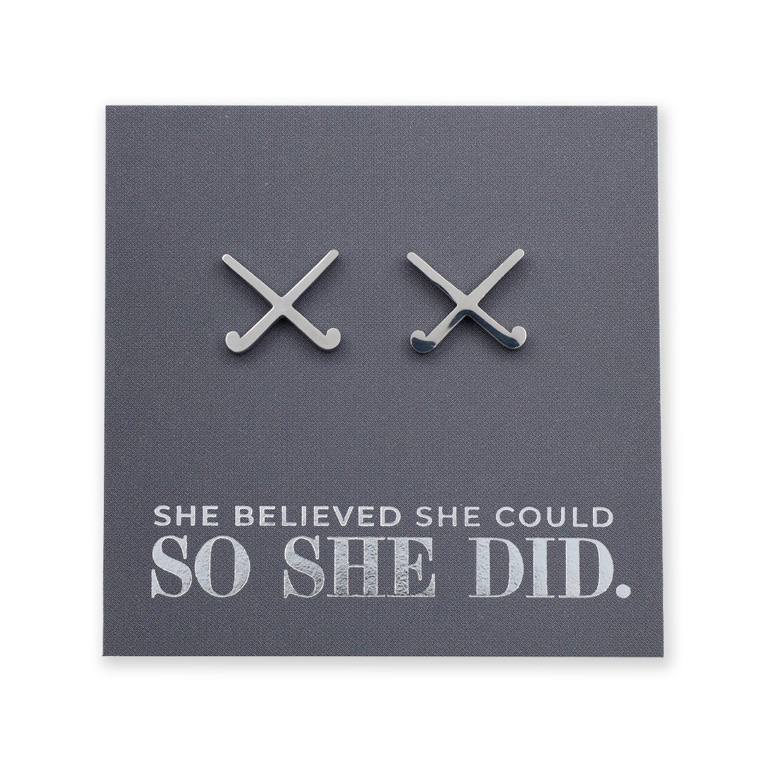 Silver hockey stud earrings on a card with 'She believed she could so she did' text