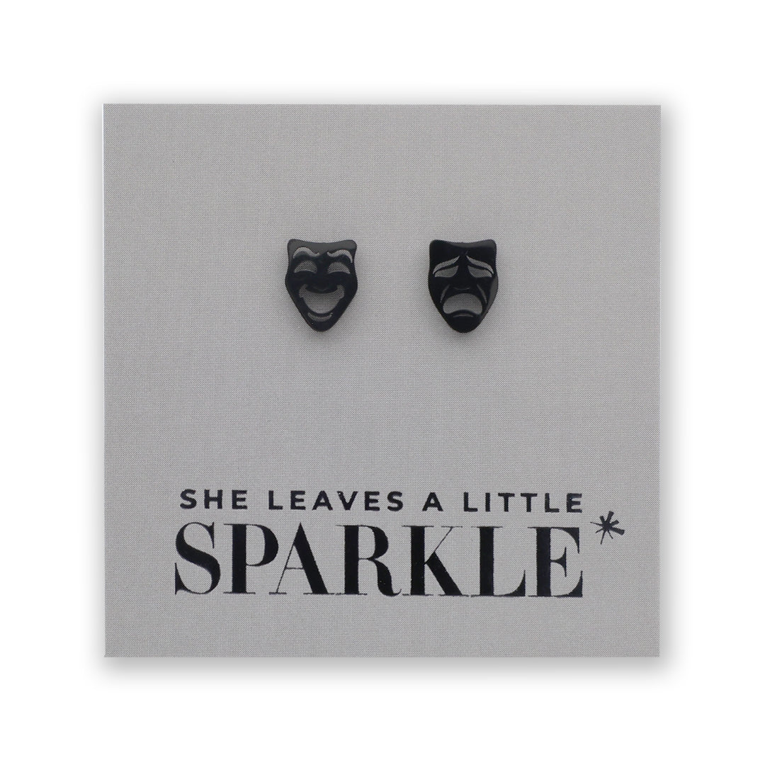Black mask-shaped earrings on a card with 'She Leaves a Little Sparkle' text.