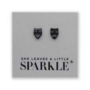 Black mask-shaped earrings on a card with 'She Leaves a Little Sparkle' text.