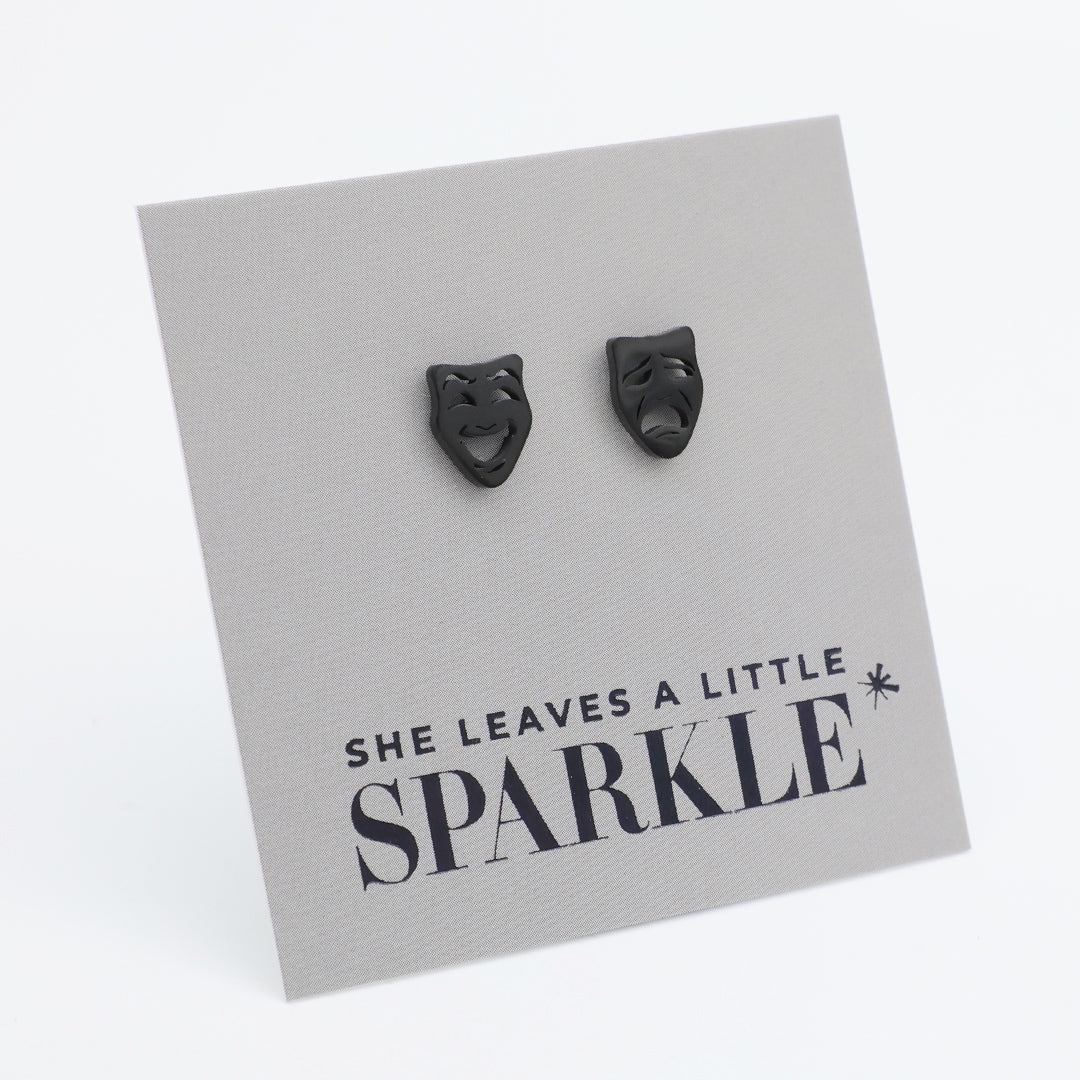Black cat-shaped earrings on a card with 'She leaves a little sparkle' text.