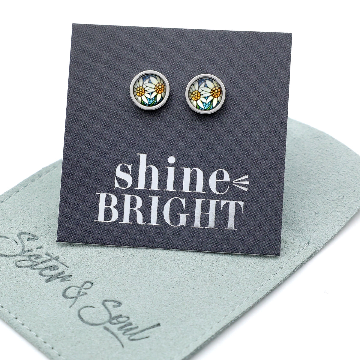 Pair of floral earrings on a 'shine BRIGHT' card with 'Sister & Soul' branding.