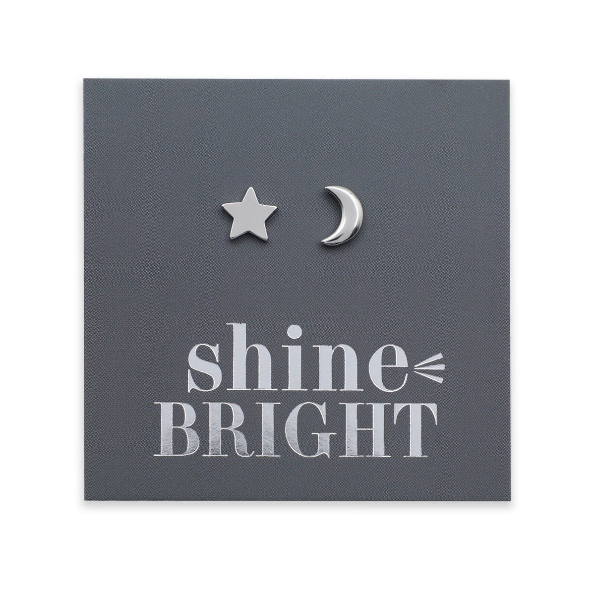 Silver star and moon earrings on a dark gray card with 'shine bright' text.