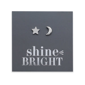 Silver star and moon earrings on a dark gray card with 'shine bright' text.