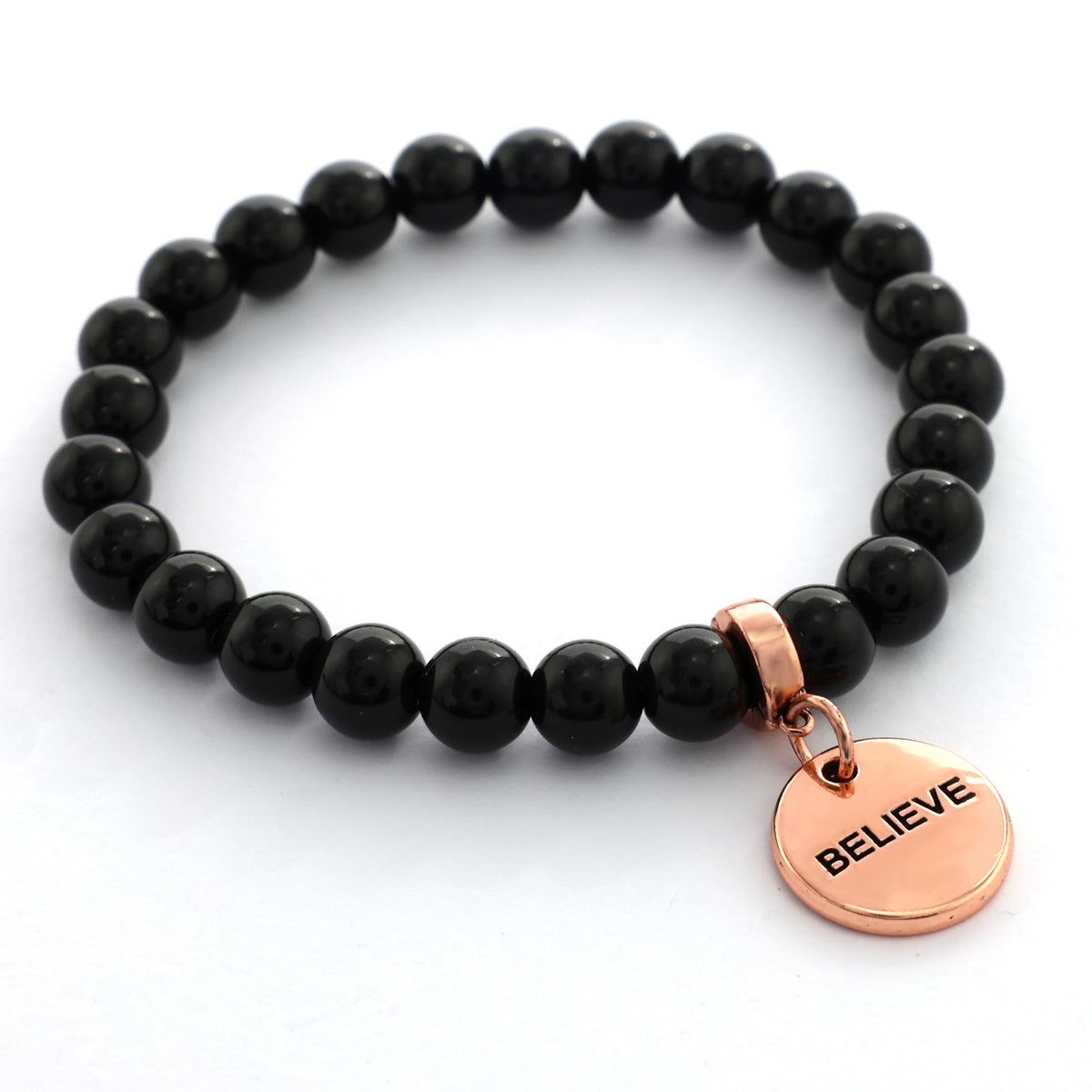 Black beaded bracelet with a rose gold 'BELIEVE' charm on a white background