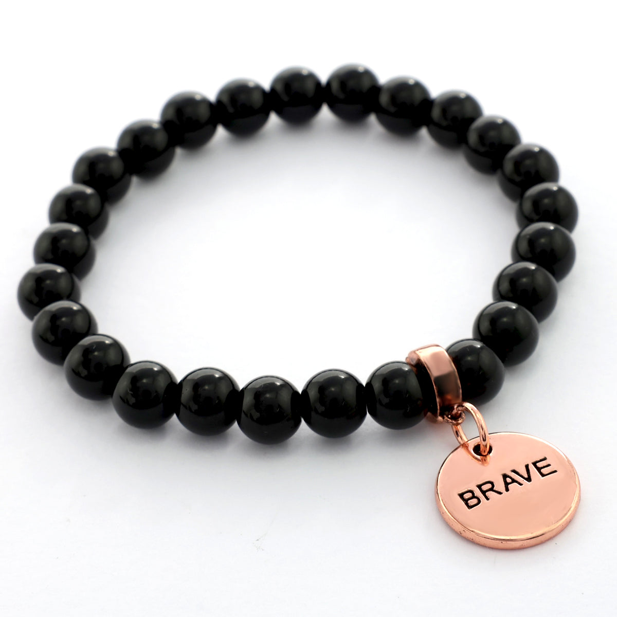 Black beaded bracelet with a rose gold 'BRAVE' charm on a white background