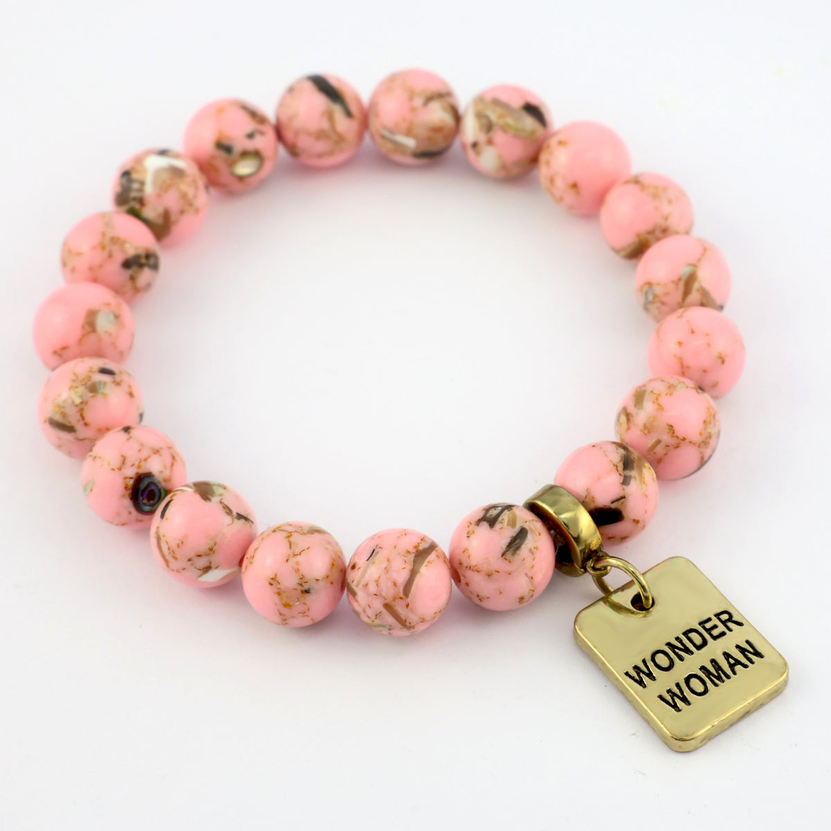 Pink beaded bracelet with a gold 'Wonder Woman' tag on a white background