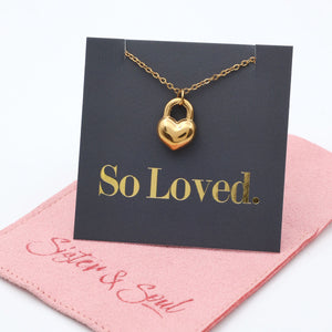 Gold heart-shaped lock necklace on a 'So Loved' card with a pink mat.