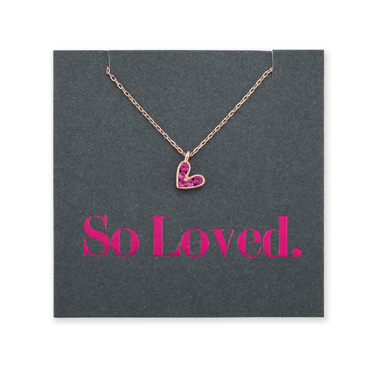 Pink heart pendant necklace sterling silver with 18K rose gold plating on gift card that has text that says so loved. 