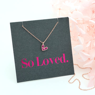 Pink heart pendant necklace sterling silver with 18K rose gold plating on gift card that has text that says so loved.