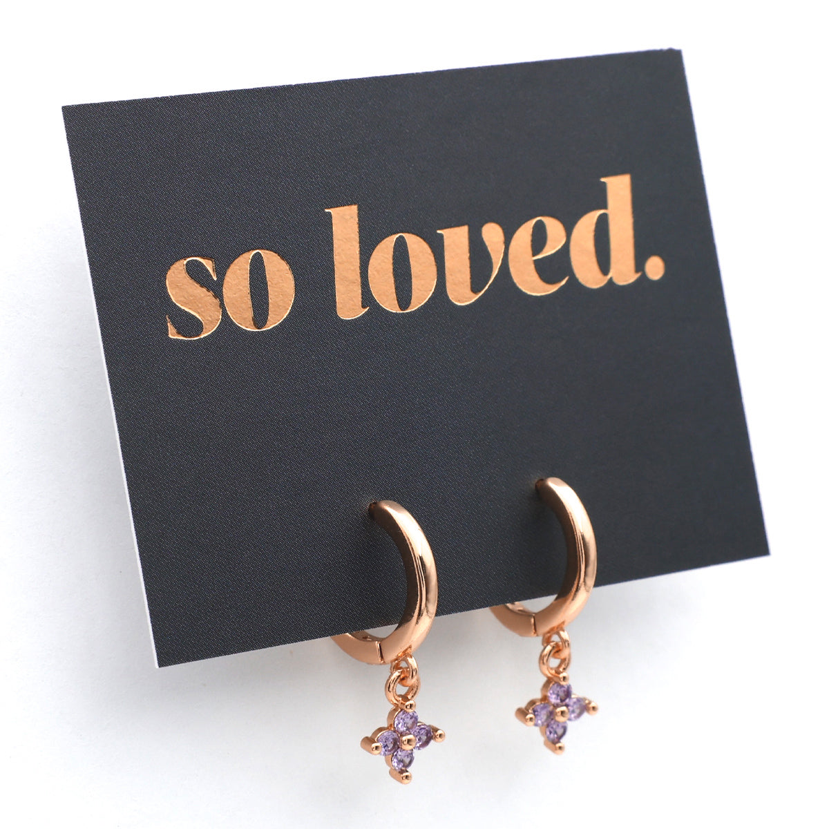Rose gold earrings with purple stones on a 'so loved' card