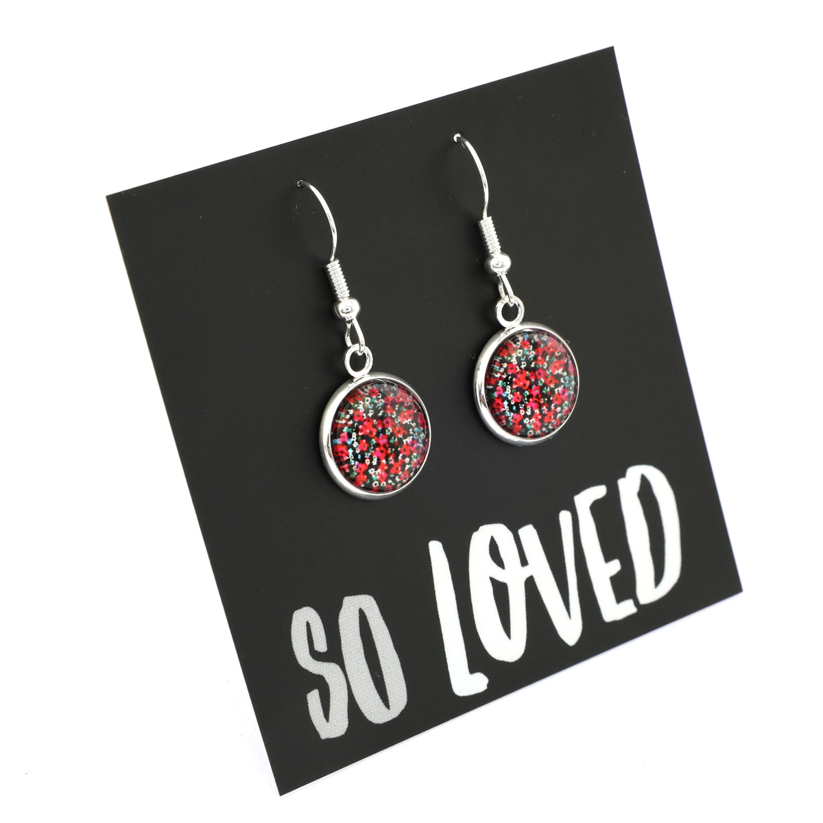 Dangle earrings with red and silver design on a 'SO LOVED' card