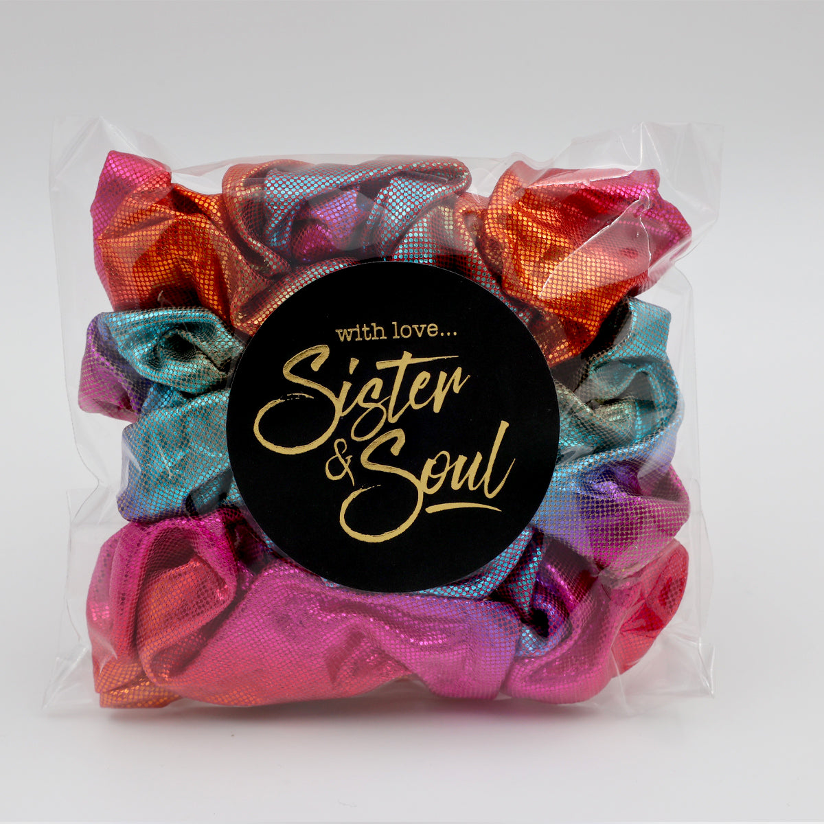 Colorful scrunchies with a 'Sister & Soul' label on a white background