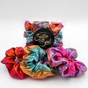 Colorful scrunchies with a 'Sister & Soul' label on a white background