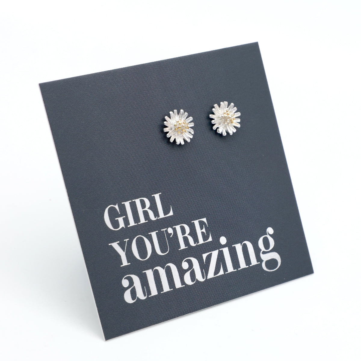 silver daisy studs on a grey card that says "girl You're Amazing" on a white background 