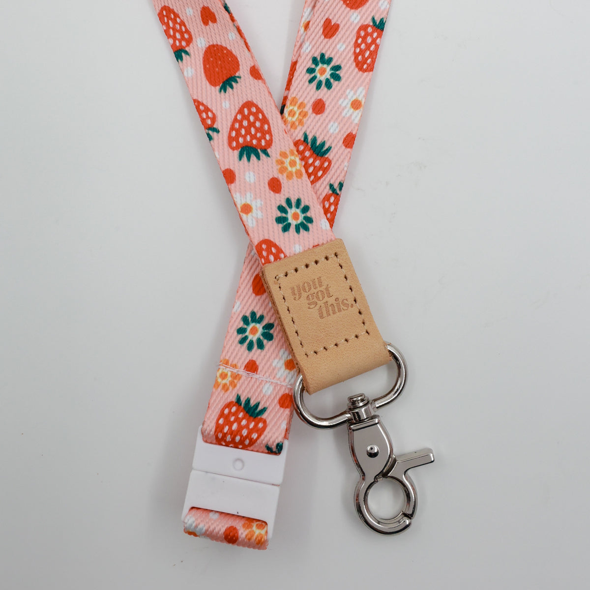You Got This embossed on a pink strawberry and flower lanyard with tan trim and a lobster clasp.