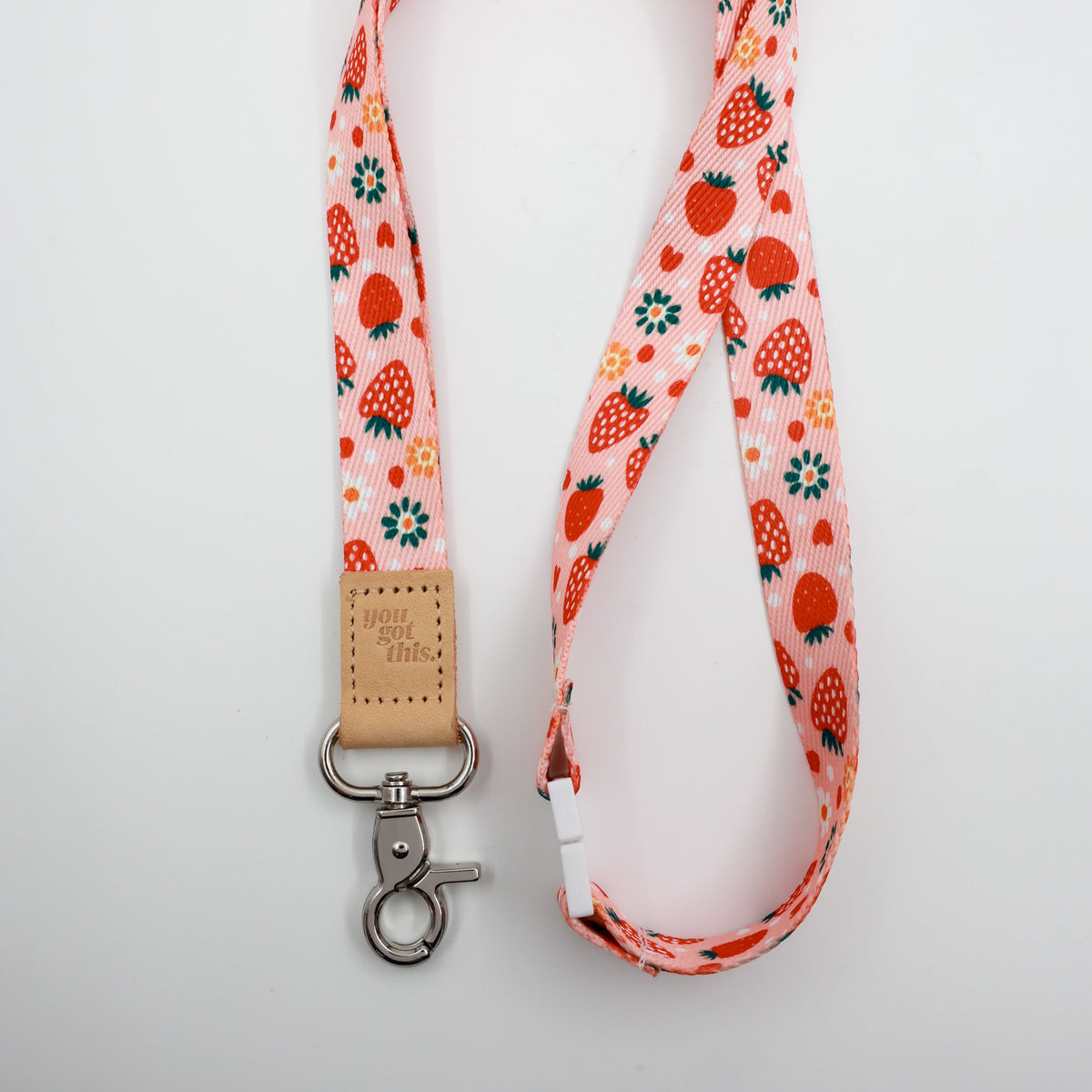 You Got This embossed on a pink strawberry and flower lanyard with tan trim and a lobster clasp.