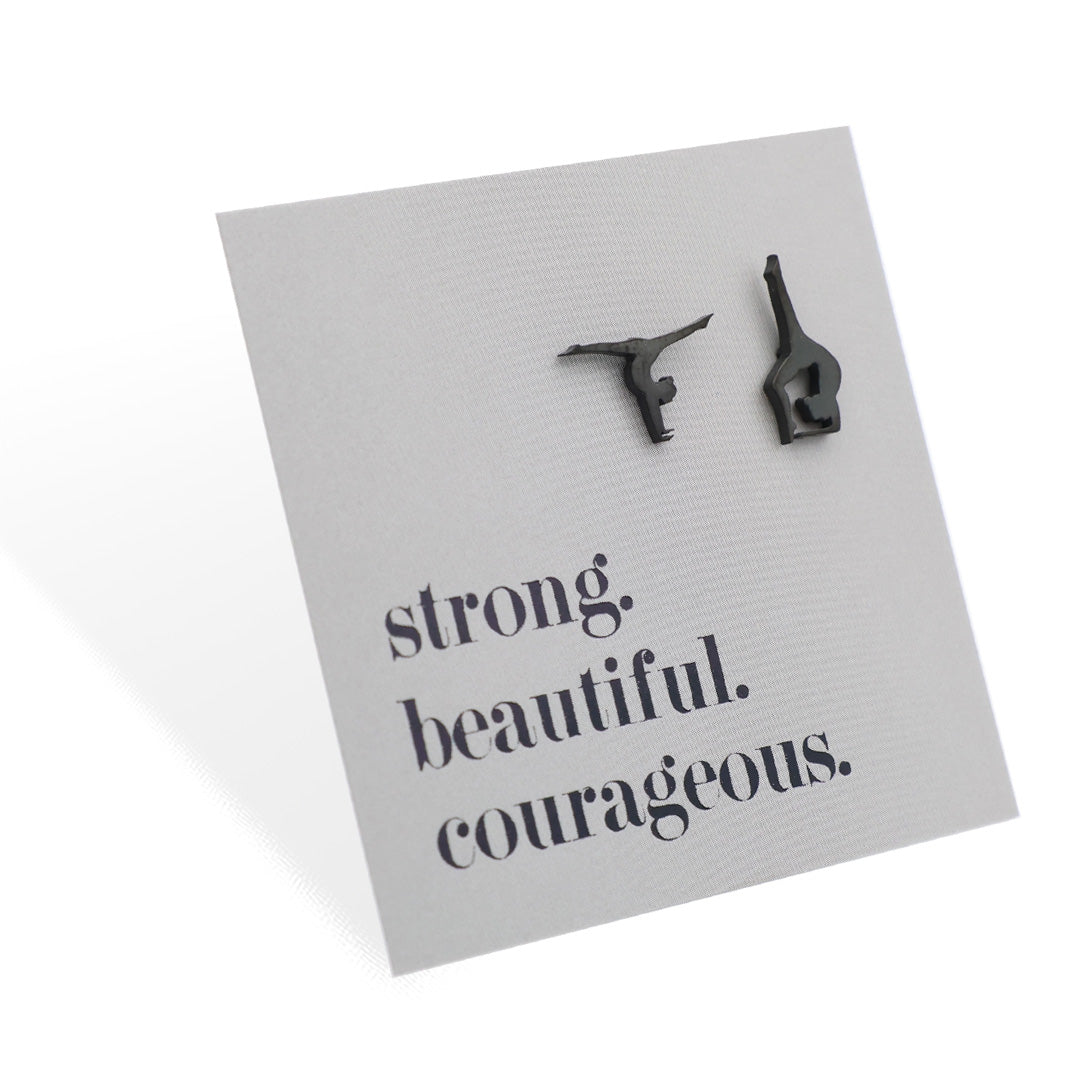 Black gymnast-shaped earrings on a card with motivational text on a grey gift card.