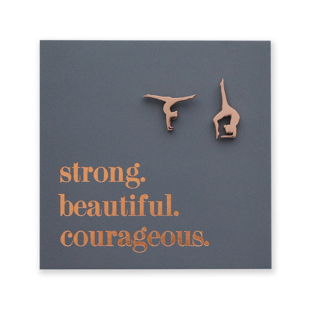 Gymnastics-themed earrings on a card with motivational text