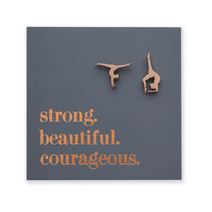 Gymnastics-themed earrings on a card with motivational text