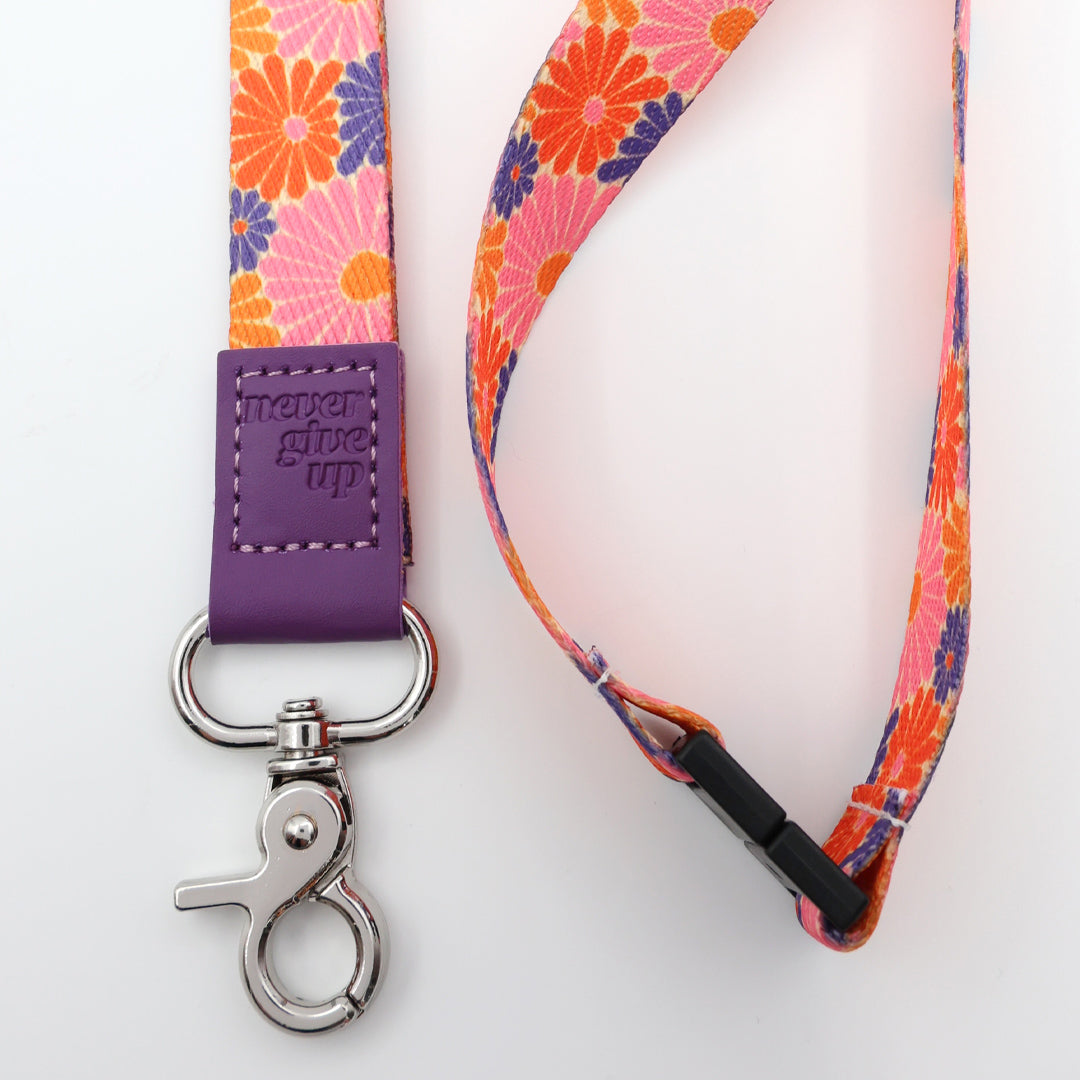 Floral patterned lanyard with purple clip on a white background