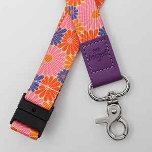 Floral lanyard with purple accent and 'so loved' tag on a white background