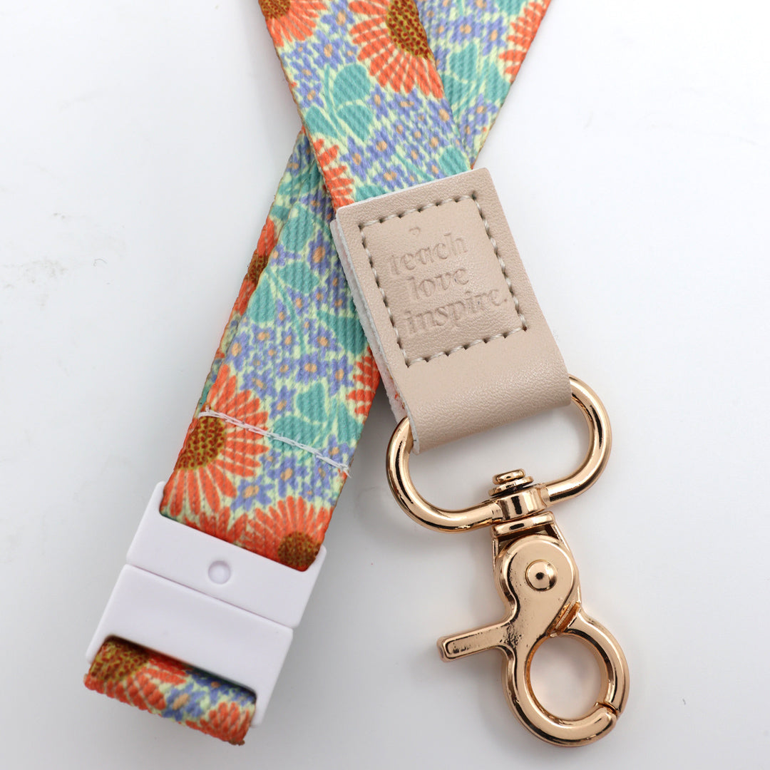 Floral lanyard with a gold clasp on a white background
