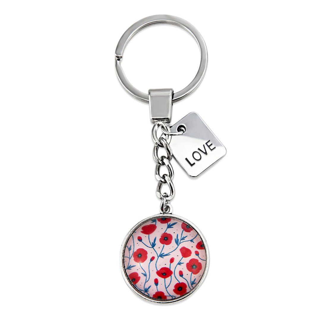 Keychain with floral design and 'LOVE' tag on a white background