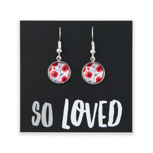 Pair of earrings with floral design on a black card with 'SO LOVED' text