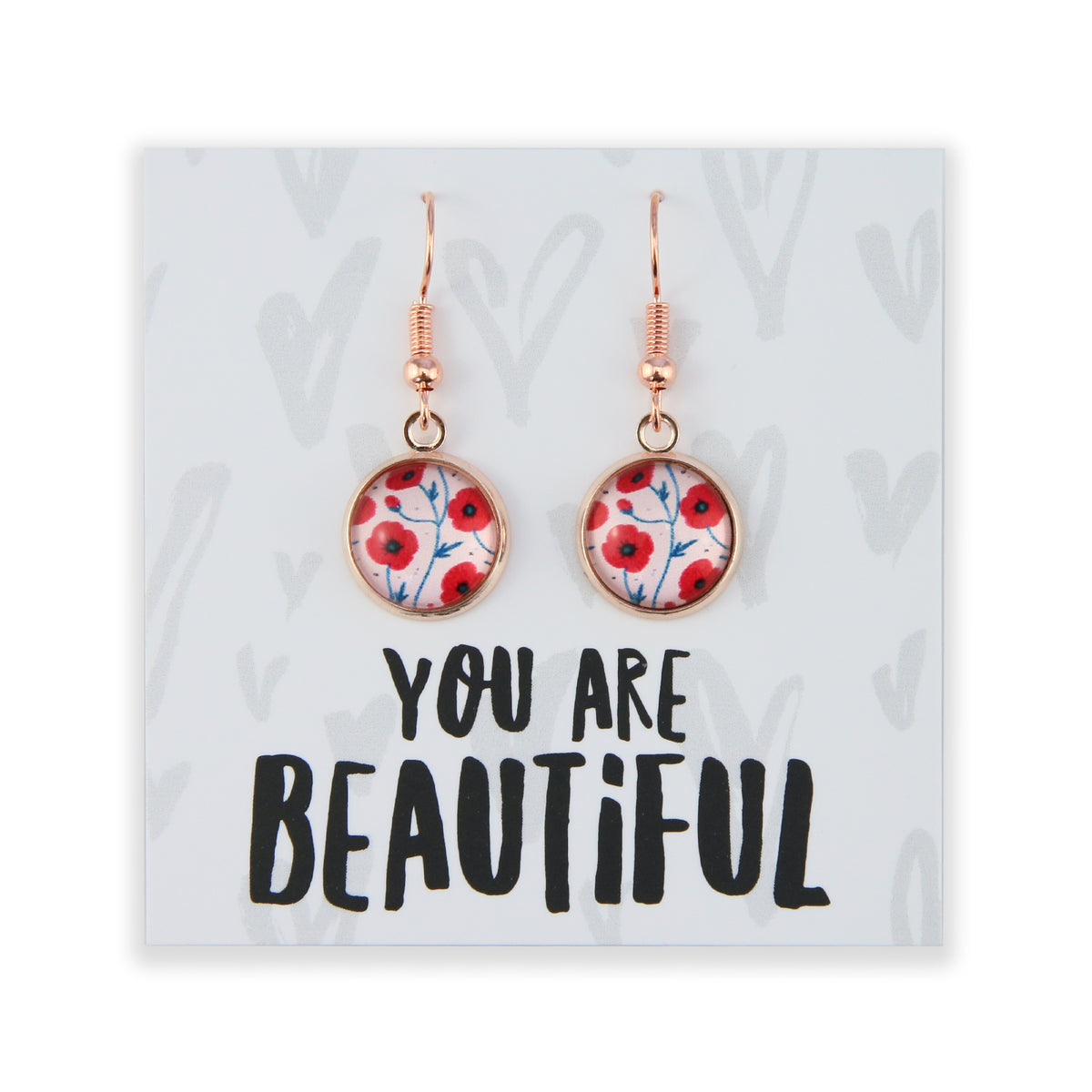 Earrings with floral design on a card with 'You are Beautiful' text