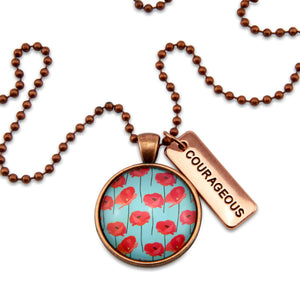 Necklace with floral pendant and 'COURAGEOUS' tag on a white background
