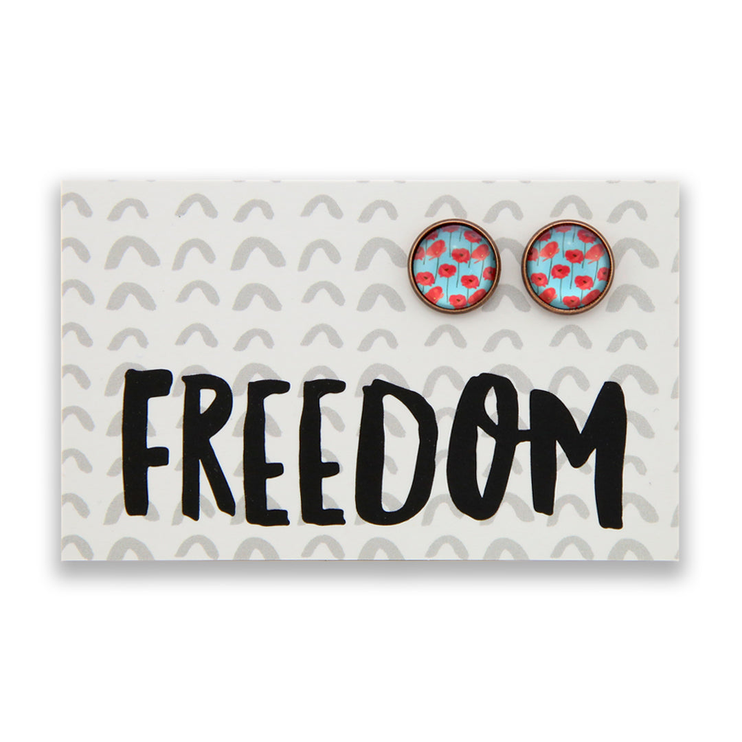 Earrings with floral design on a card with 'FREEDOM' text