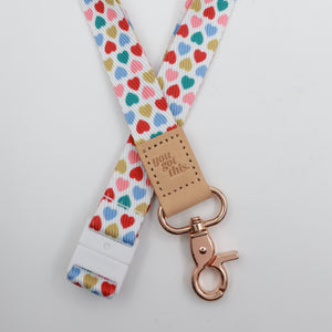 You Got This embossed on a white lanyard with multicoloured hearts and tan trim and a lobster clasp.