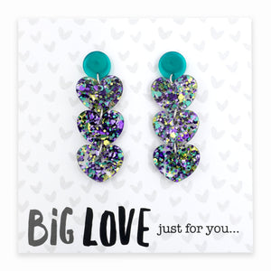 Pair of heart-shaped earrings with glittery finish on a card with 'Big Love just for you' text.